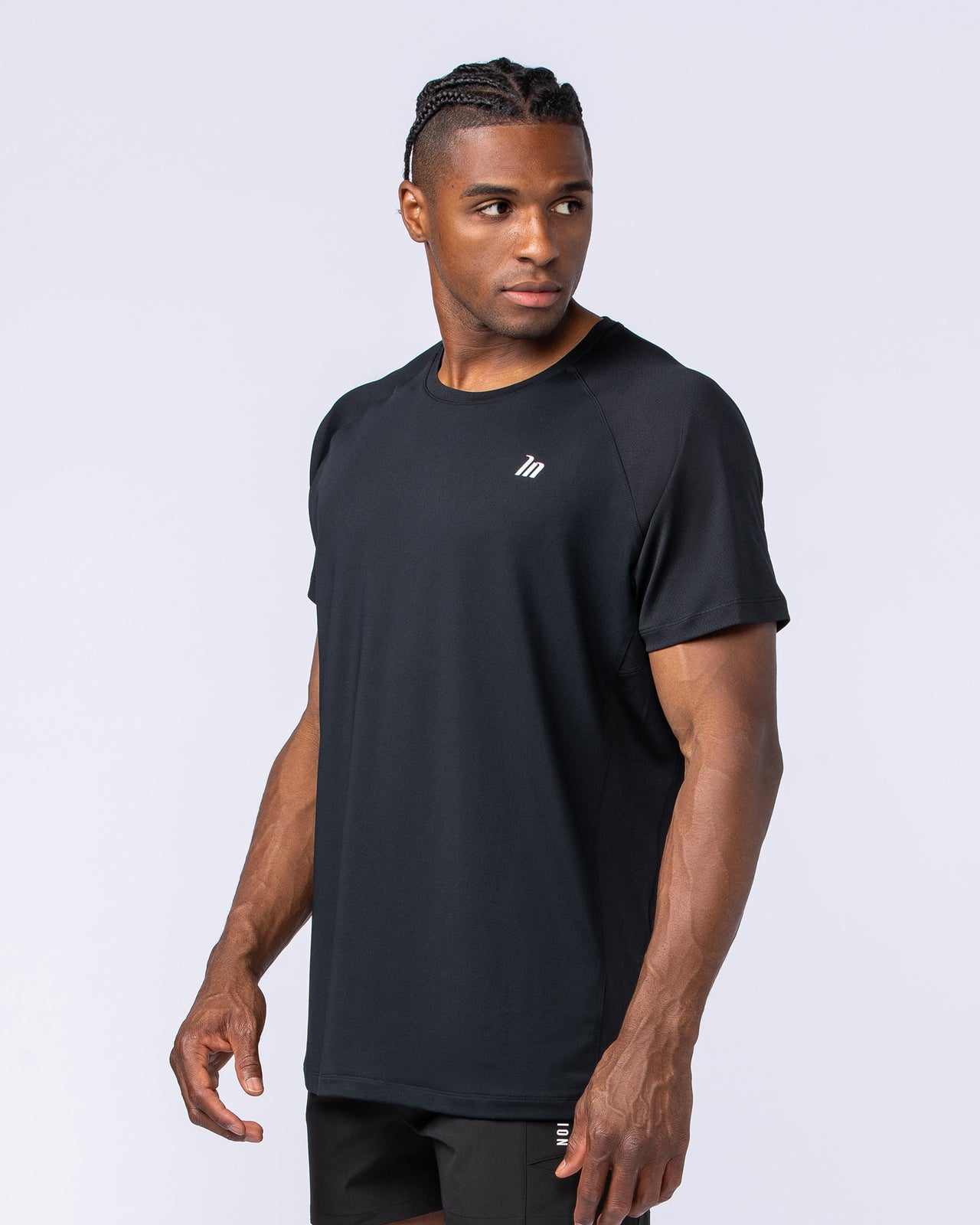 Muscle Nation Ventilation Tee in black on a male model - men's lightweight breathable gym tee, alternate view