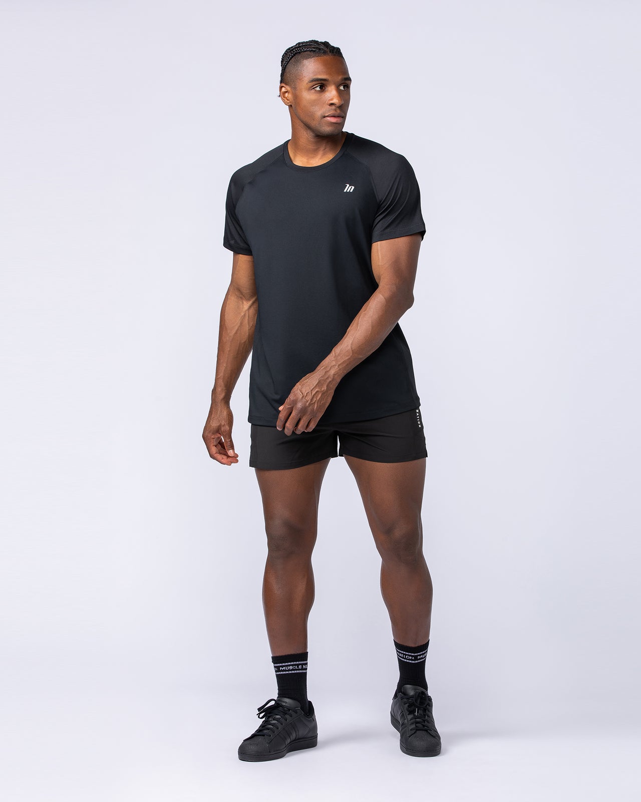 Black Ventilation Tee on a male model - Muscle Nation lightweight training tee, studio view